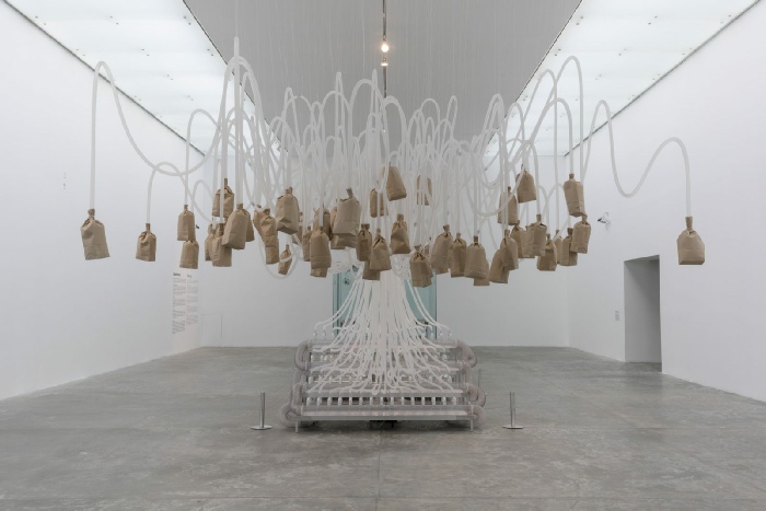 Rafael Lozano-Hemmer, Vicious Circular Breathing, 2013. Vue de l’exposition Rafael Lozano-Hemmer: Pseudomatismos, MUAC, Mexico, Mexique, 2015. Prisme de verre scellé monté sur une porte coulissante automatique, soufflets motorisés, bloc de vannes électromagnétiques, 61 sacs de papier brun, système de circulation adapté, tubulure de respiration, capteurs, ordinateur © Rafael Lozano-Hemmer / SODRAC 2018 Photo : Olivier Santana 